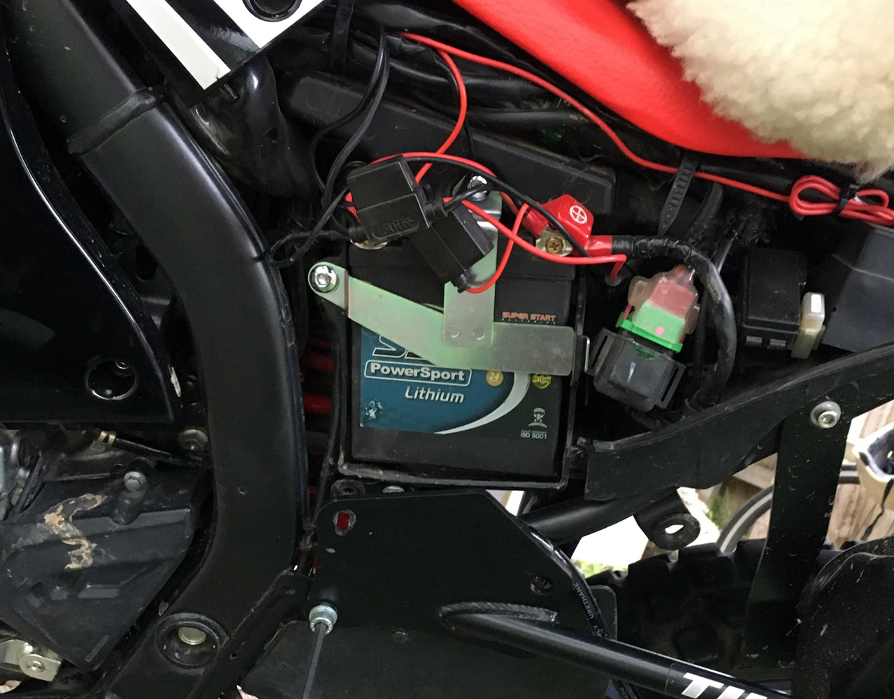 The SSB LH71-BS lithium ion battery installed on the Honda CRF250 Rally
